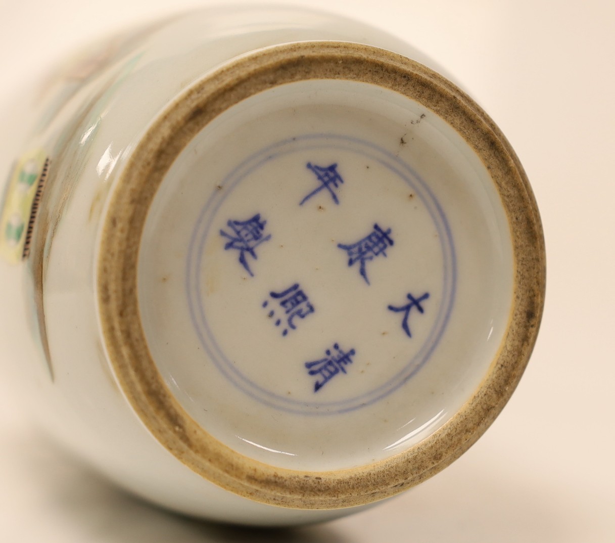 A Chinese famille verte rouleau vase depicting figures in landscape, 22.5cm tall